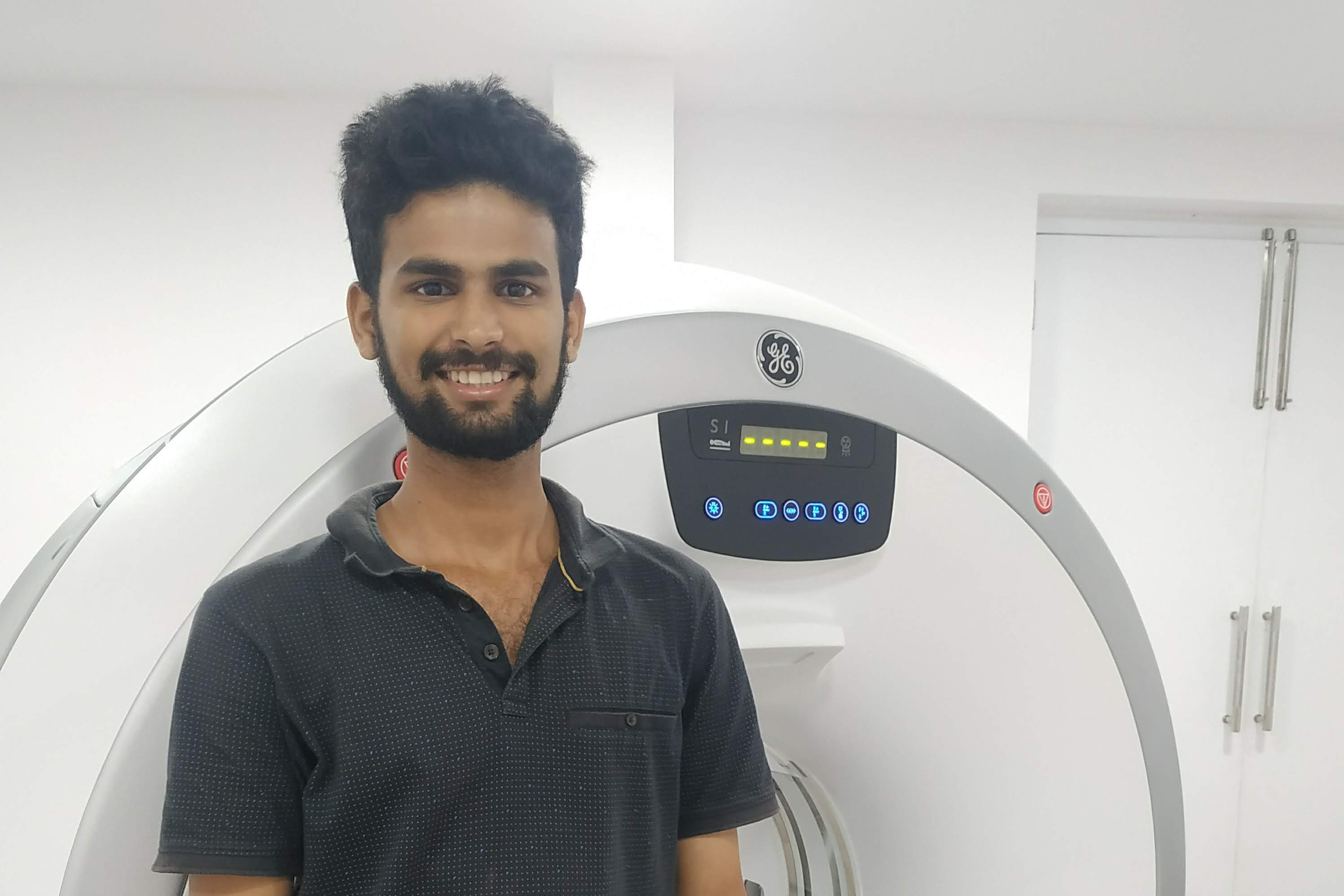 ct field service engineer working on a CT machine in a hospital setting