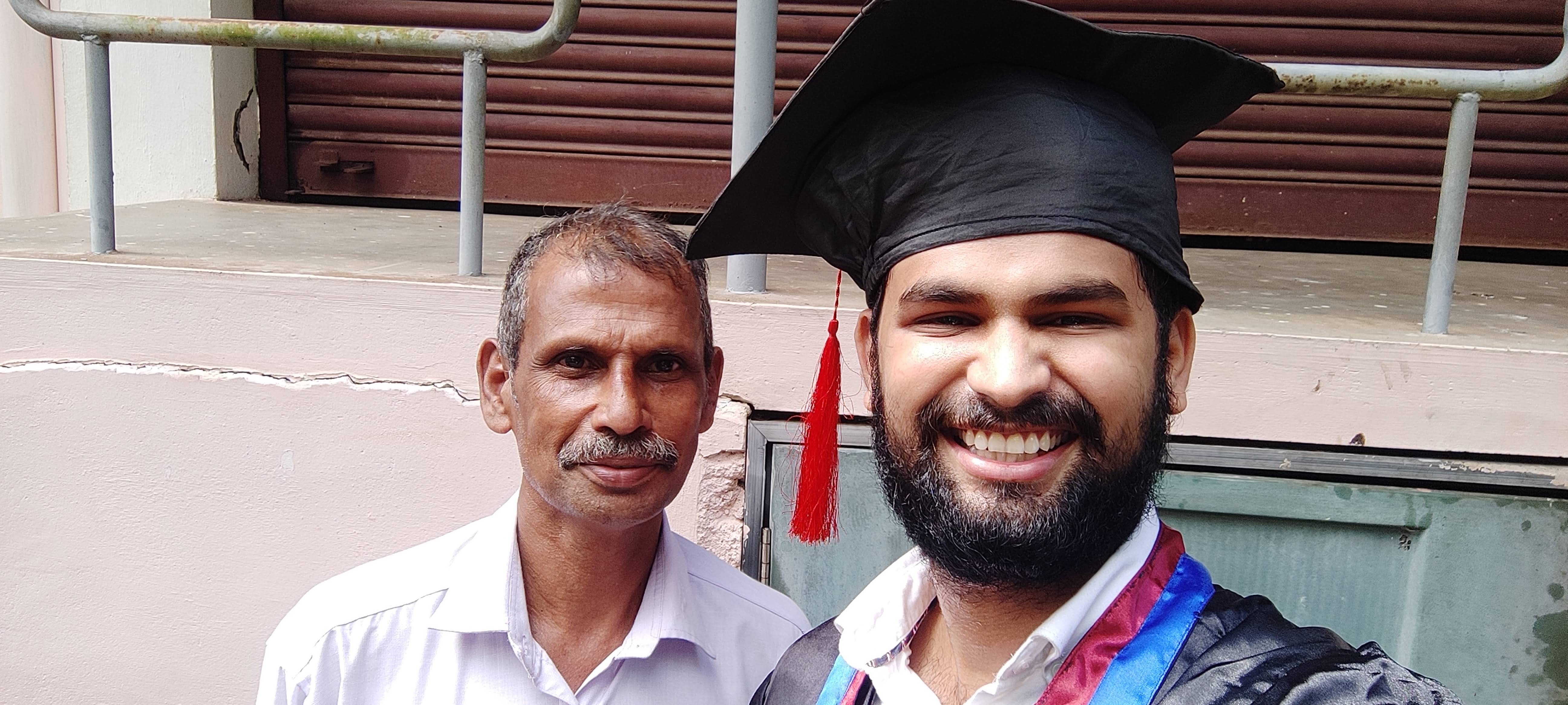 Aju and his father celebrating graduation day with a selfie